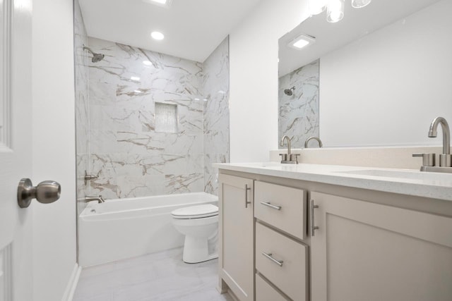 full bathroom with tiled shower / bath, vanity, and toilet