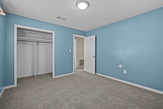 unfurnished bedroom with a closet and carpet