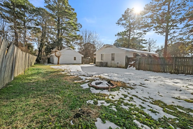 yard layered in snow featuring an outdoor structure