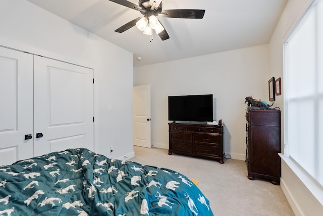 bedroom with light carpet, a closet, and ceiling fan