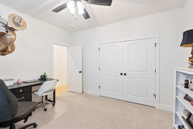 home office featuring light carpet and ceiling fan