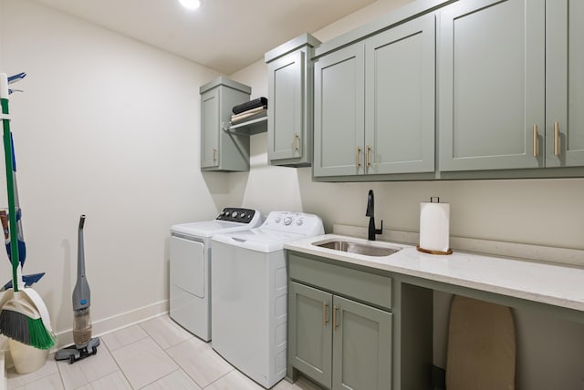 washroom with cabinets, washer and clothes dryer, sink, and light tile patterned floors