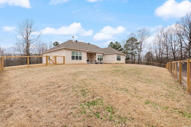 rear view of property with a yard