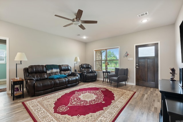 living room featuring hardwood / wood-style flooring and ceiling fan