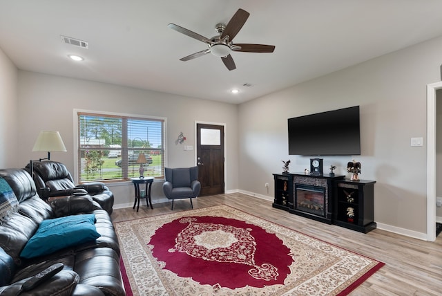 living room featuring hardwood / wood-style flooring and ceiling fan