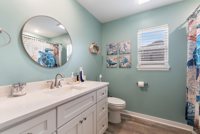 bathroom featuring vanity, hardwood / wood-style floors, and toilet