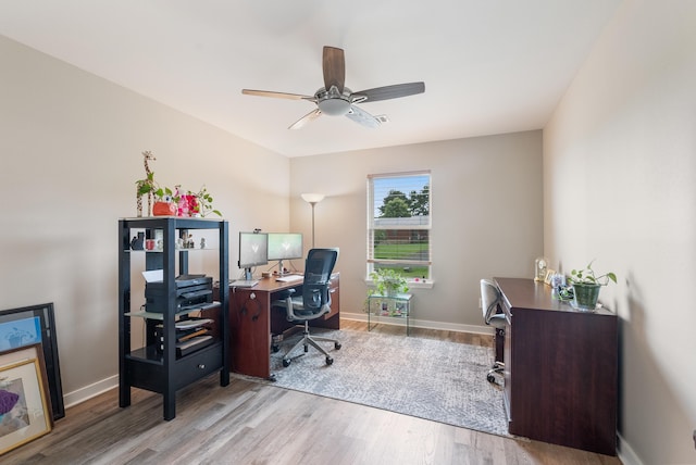 office space featuring ceiling fan and light hardwood / wood-style floors