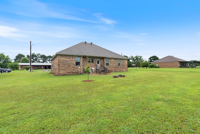 rear view of house with a yard