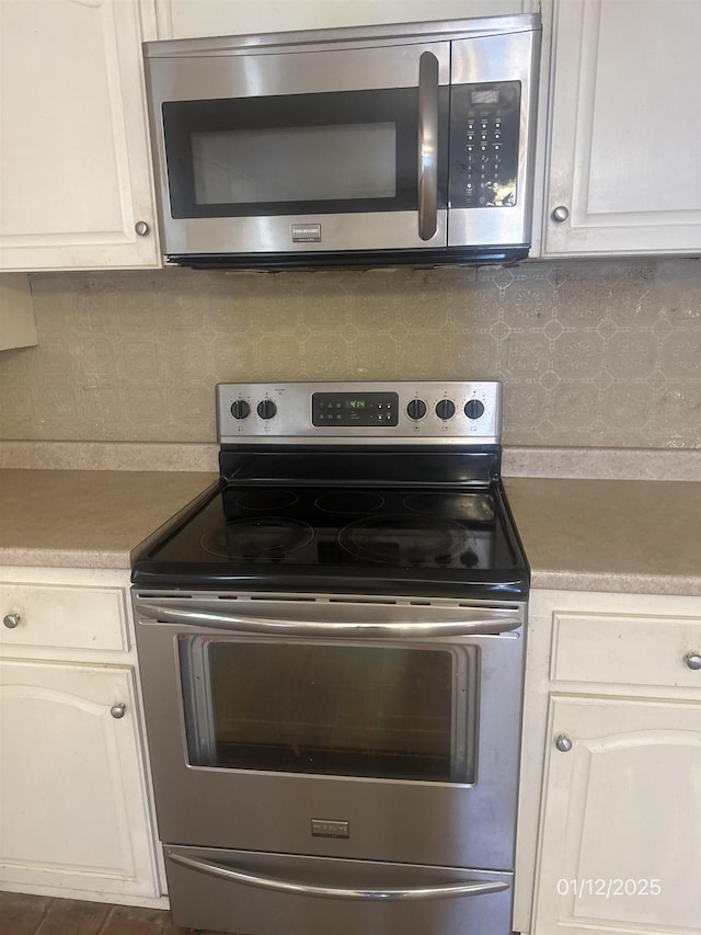 1013 Elm St, Coal Hill, AR 72832 - kitchen with white cabinetry, appliances with stainless steel finishes, and backsplash