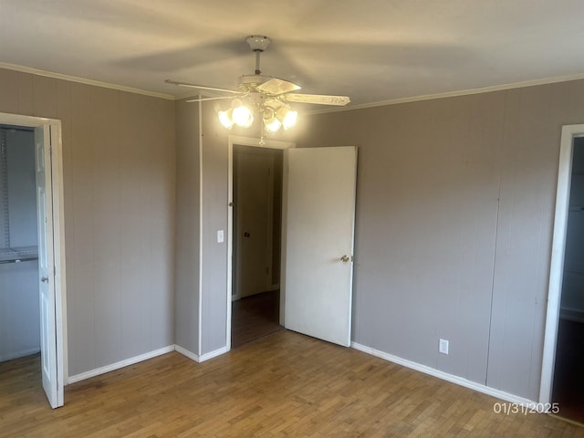 1013 Elm St, Coal Hill, AR 72832 - unfurnished bedroom with crown molding, a closet, ceiling fan, and light wood-type flooring