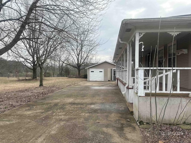 1013 Elm St, Coal Hill, AR 72832 - view of property exterior with an outbuilding and a garage