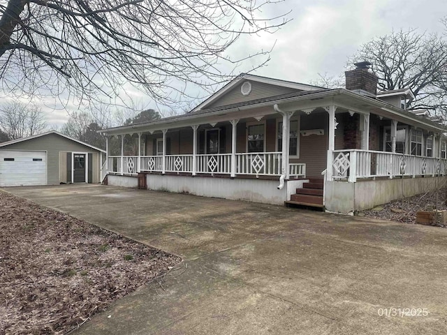 1013 Elm St, Coal Hill, AR 72832 - country-style home with an outbuilding, a garage, and covered porch