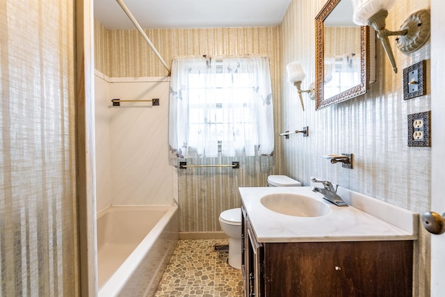 full bathroom featuring washtub / shower combination, vanity, and toilet