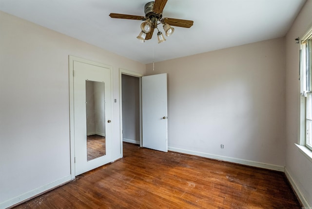 unfurnished bedroom with ceiling fan and wood-type flooring