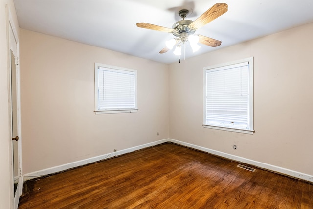 empty room with dark wood-type flooring and ceiling fan