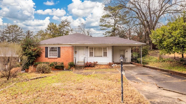 ranch-style house with a front yard and a carport