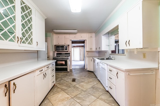 kitchen featuring sink, white dishwasher, gas stove, and white cabinets