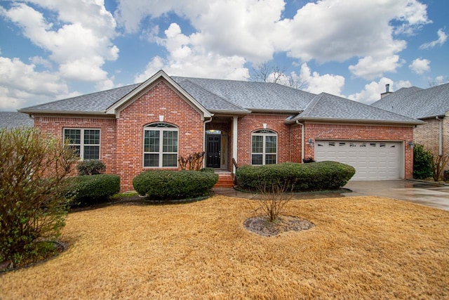 ranch-style home with a garage and a front yard