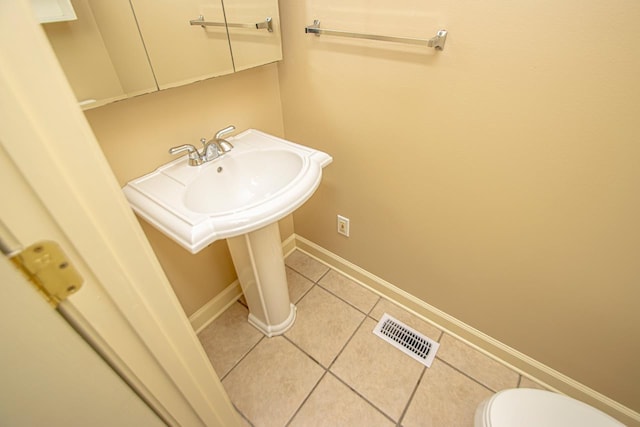 bathroom featuring tile patterned floors and toilet