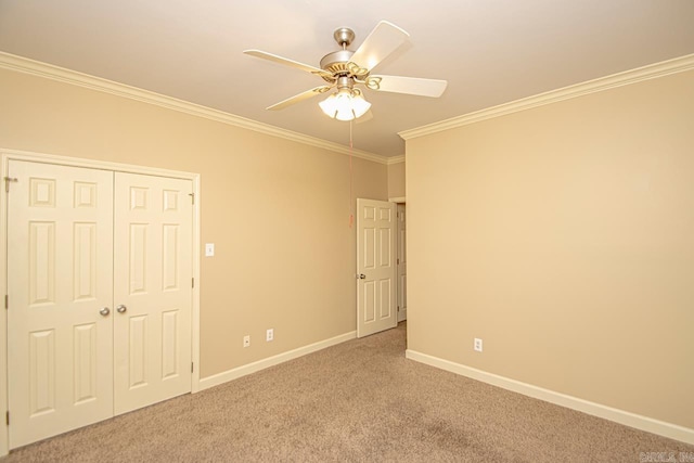 unfurnished bedroom featuring ornamental molding, a closet, ceiling fan, and carpet