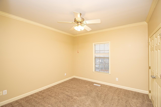 carpeted spare room featuring ornamental molding and ceiling fan
