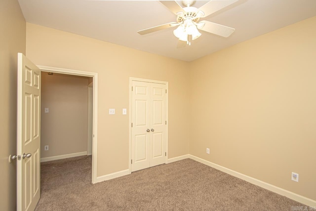 unfurnished bedroom featuring ceiling fan and carpet flooring