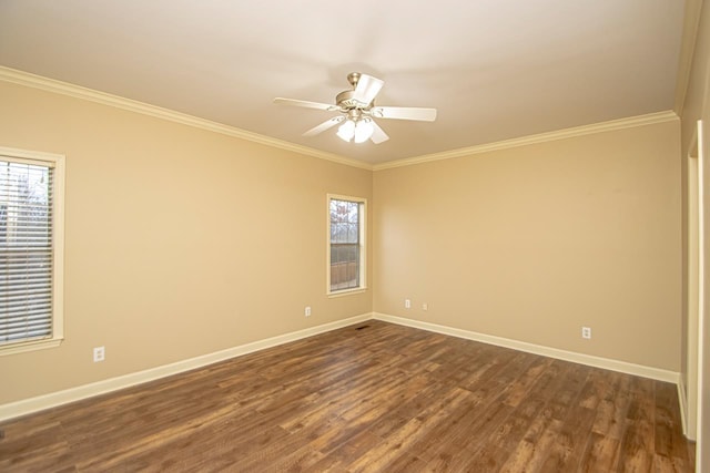 unfurnished room with dark wood-type flooring, ornamental molding, and a wealth of natural light