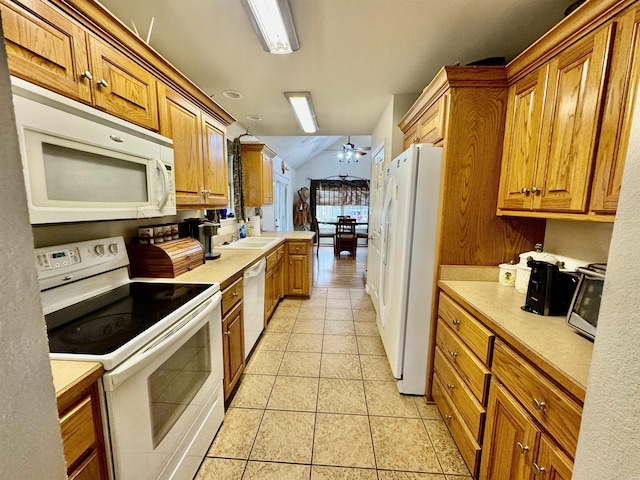 kitchen featuring light tile patterned flooring, lofted ceiling, sink, ceiling fan, and white appliances