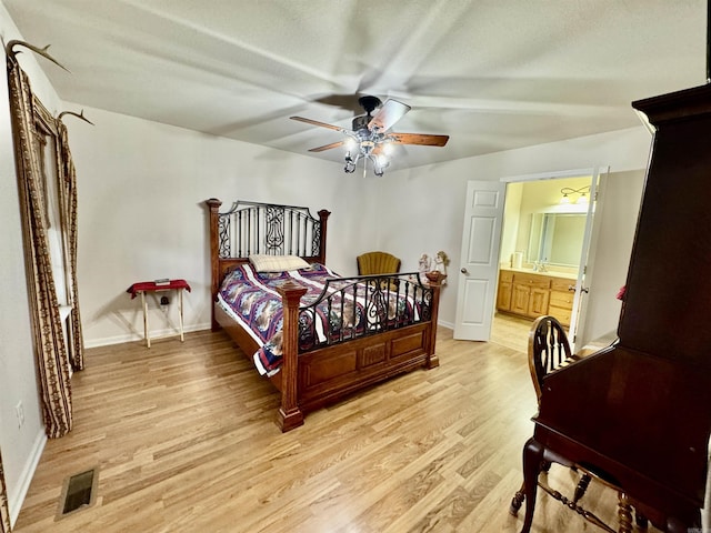 bedroom featuring ceiling fan, connected bathroom, and light hardwood / wood-style floors