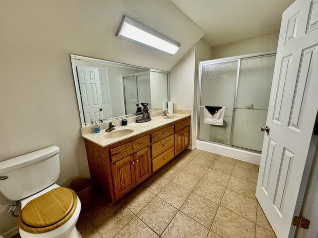 bathroom with vanity, toilet, an enclosed shower, and tile patterned flooring