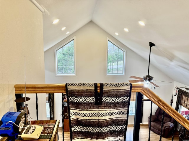 stairway featuring wood-type flooring, lofted ceiling, plenty of natural light, and ceiling fan