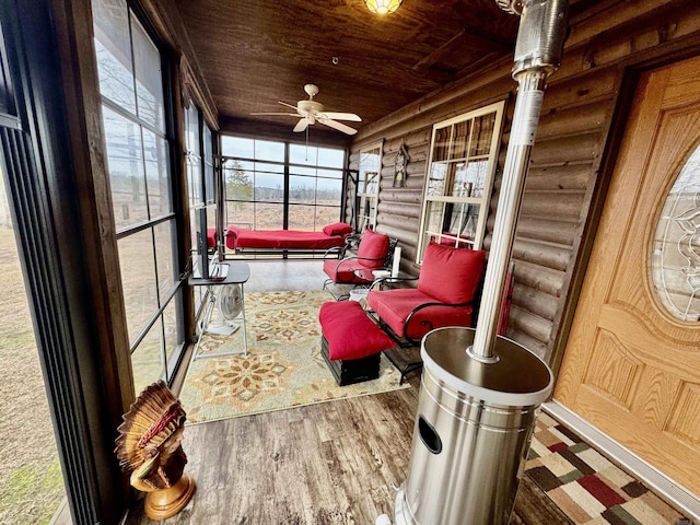 sunroom featuring wood ceiling and ceiling fan