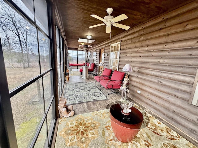 sunroom featuring ceiling fan and wooden ceiling