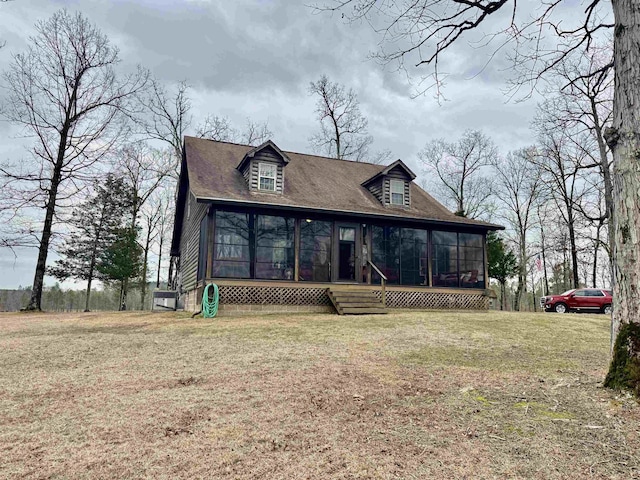 view of front of property featuring a front yard and a sunroom