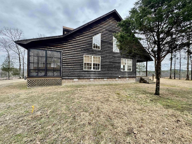 view of side of home with a lawn