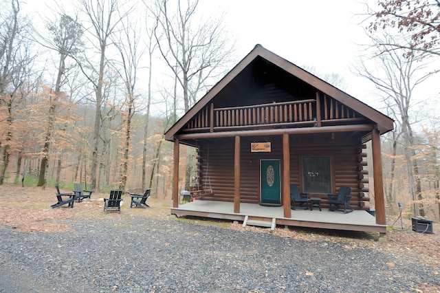 log-style house featuring a porch