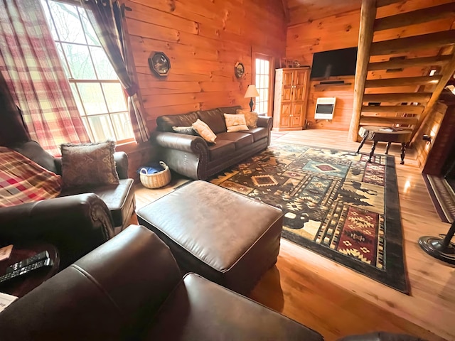 living room featuring wooden walls and light hardwood / wood-style flooring