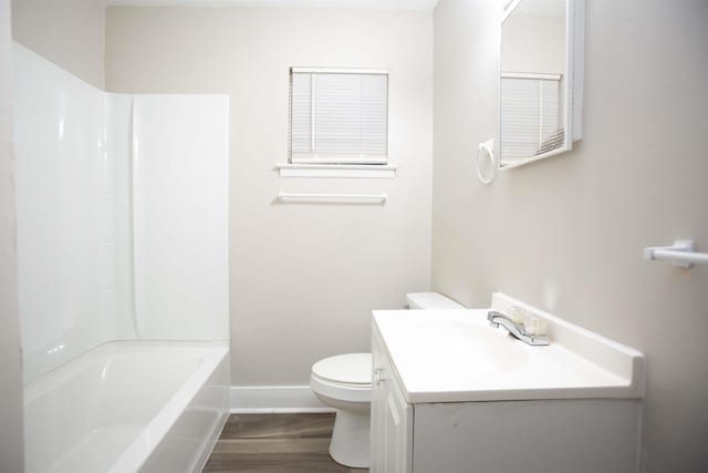 full bathroom featuring vanity, toilet,  shower combination, and wood-type flooring