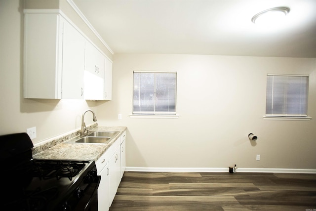 kitchen featuring black range with gas cooktop, sink, dark wood-type flooring, and white cabinets