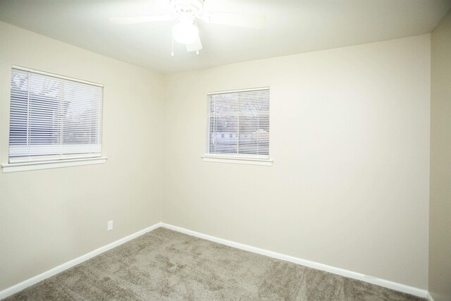 carpeted empty room featuring ceiling fan