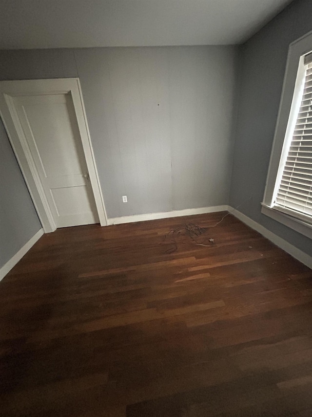 empty room with dark hardwood / wood-style floors