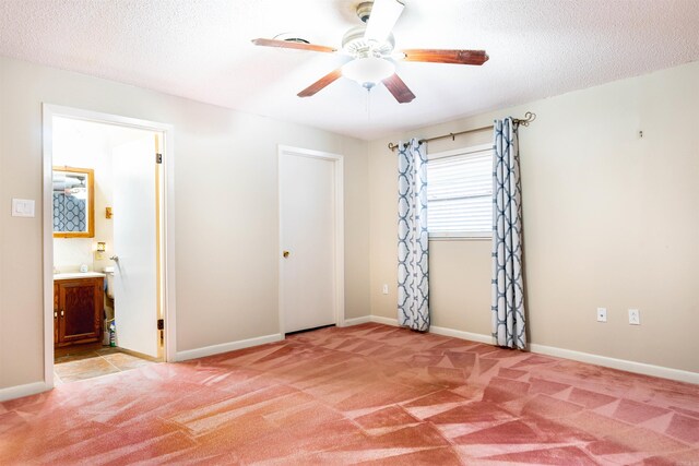 spare room featuring a textured ceiling, light colored carpet, baseboards, and ceiling fan