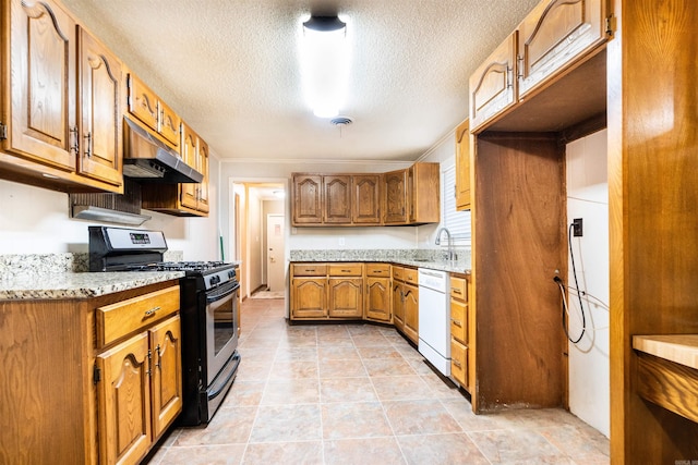 kitchen featuring brown cabinetry, stainless steel gas range, under cabinet range hood, a textured ceiling, and dishwasher