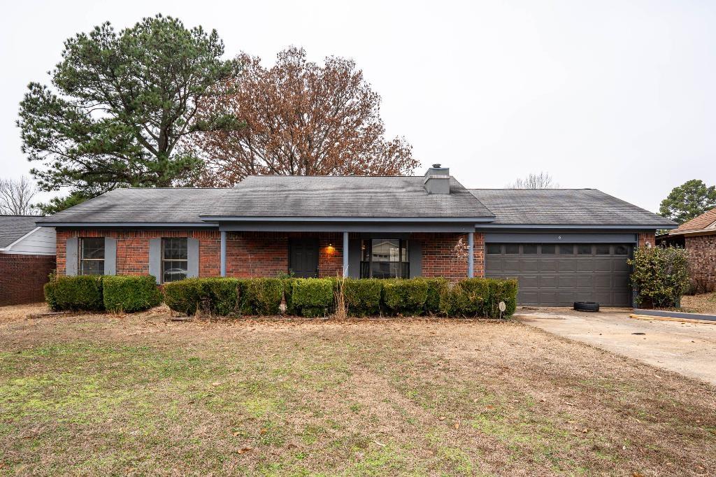 single story home with a garage and a front yard