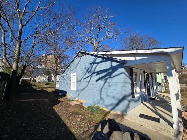 view of property exterior featuring covered porch