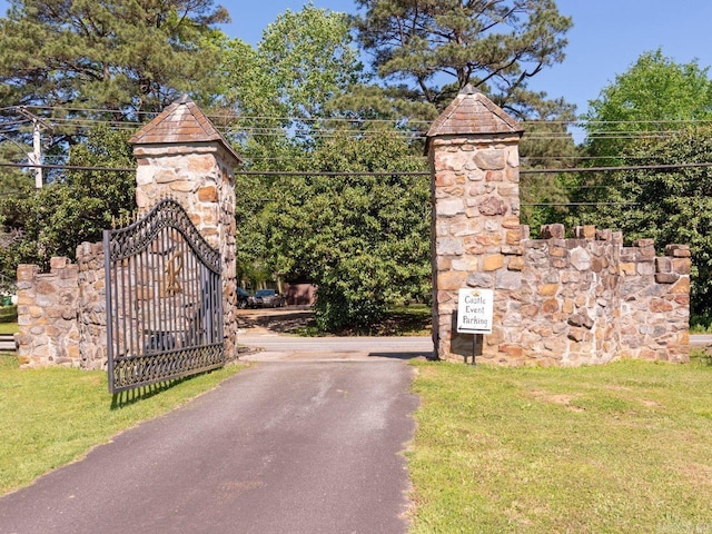 view of gate with a yard