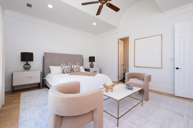 bedroom with ensuite bathroom, lofted ceiling, ceiling fan, light hardwood / wood-style floors, and crown molding