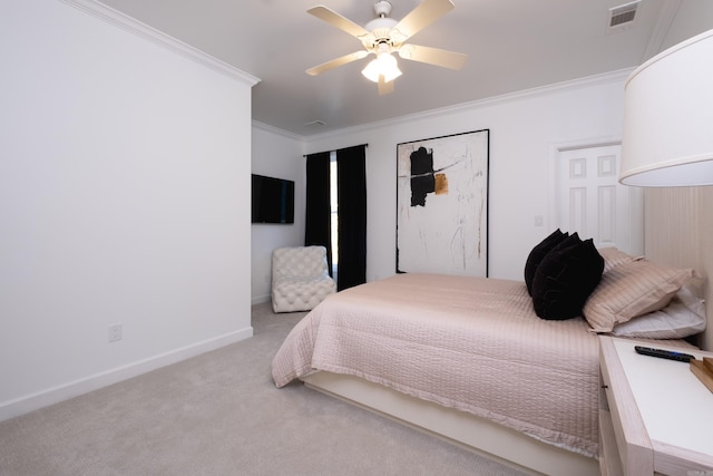 carpeted bedroom with ornamental molding and ceiling fan