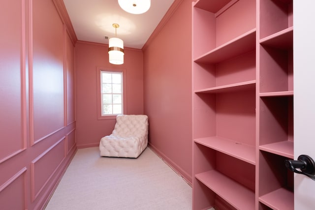 living area featuring crown molding and light colored carpet