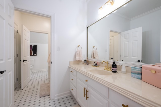 bathroom with crown molding, vanity, and toilet